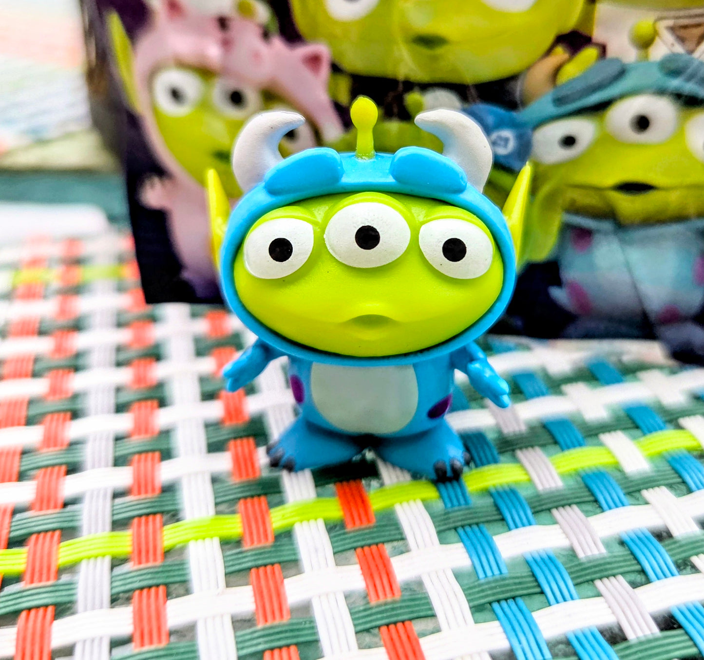 Green alien mini figure with round eyes, blue helmet, and blue suit