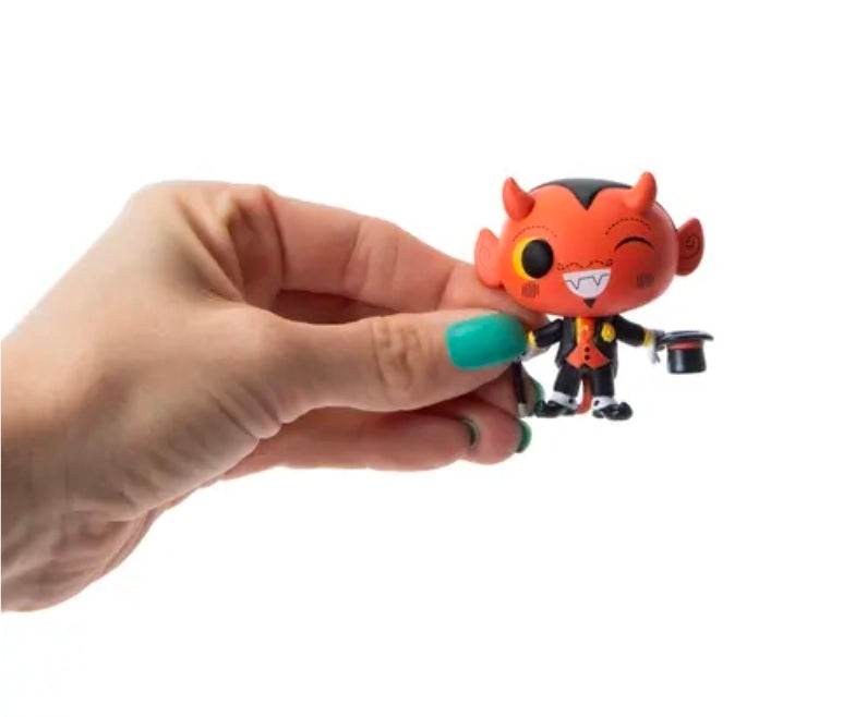 Orange and black Halloween vinyl mini figure holding two small buckets and tool