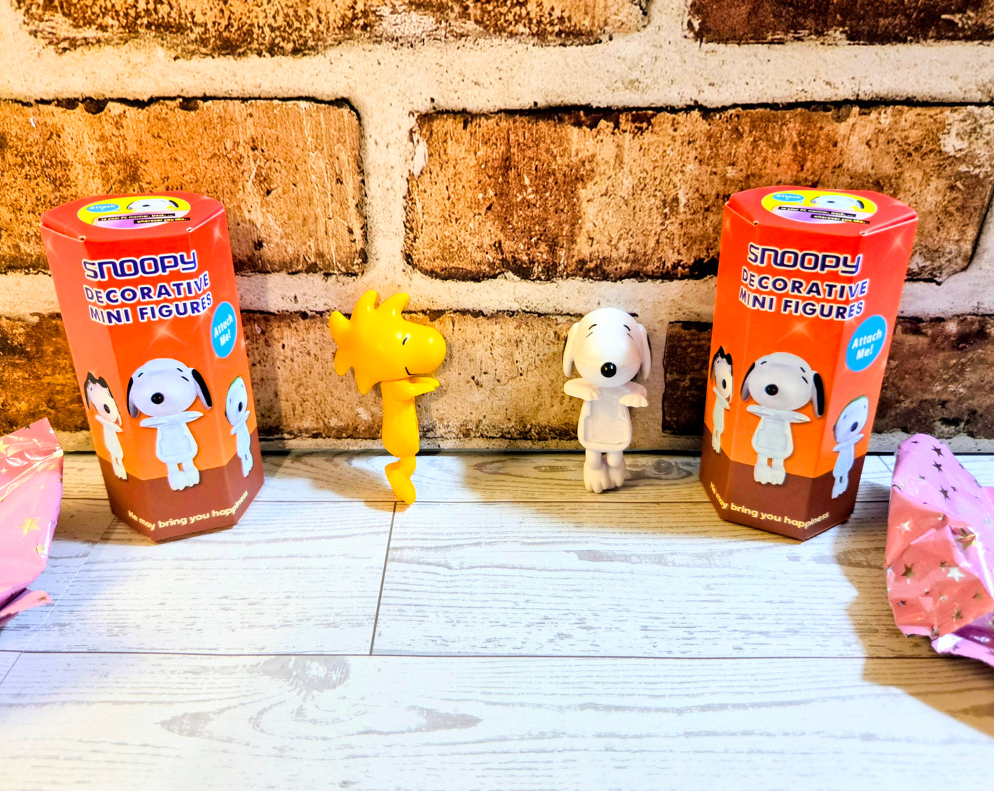 Two boxed mini character figures with yellow and white figures shown on orange packaging