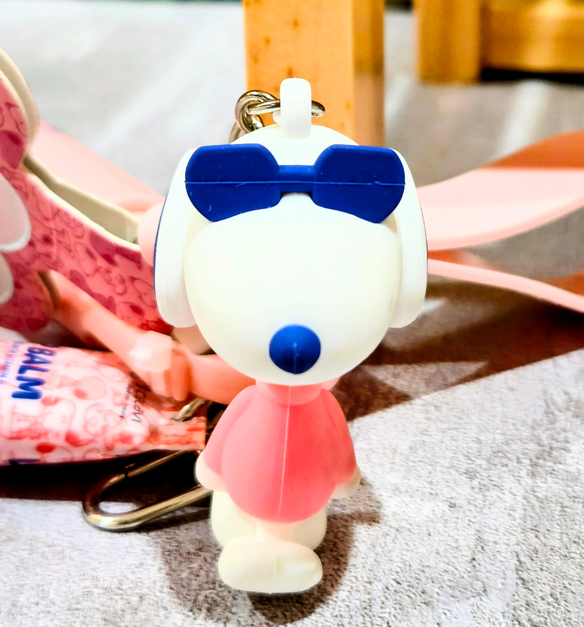 Snoopy glow keychain figure with blue details and small white stand