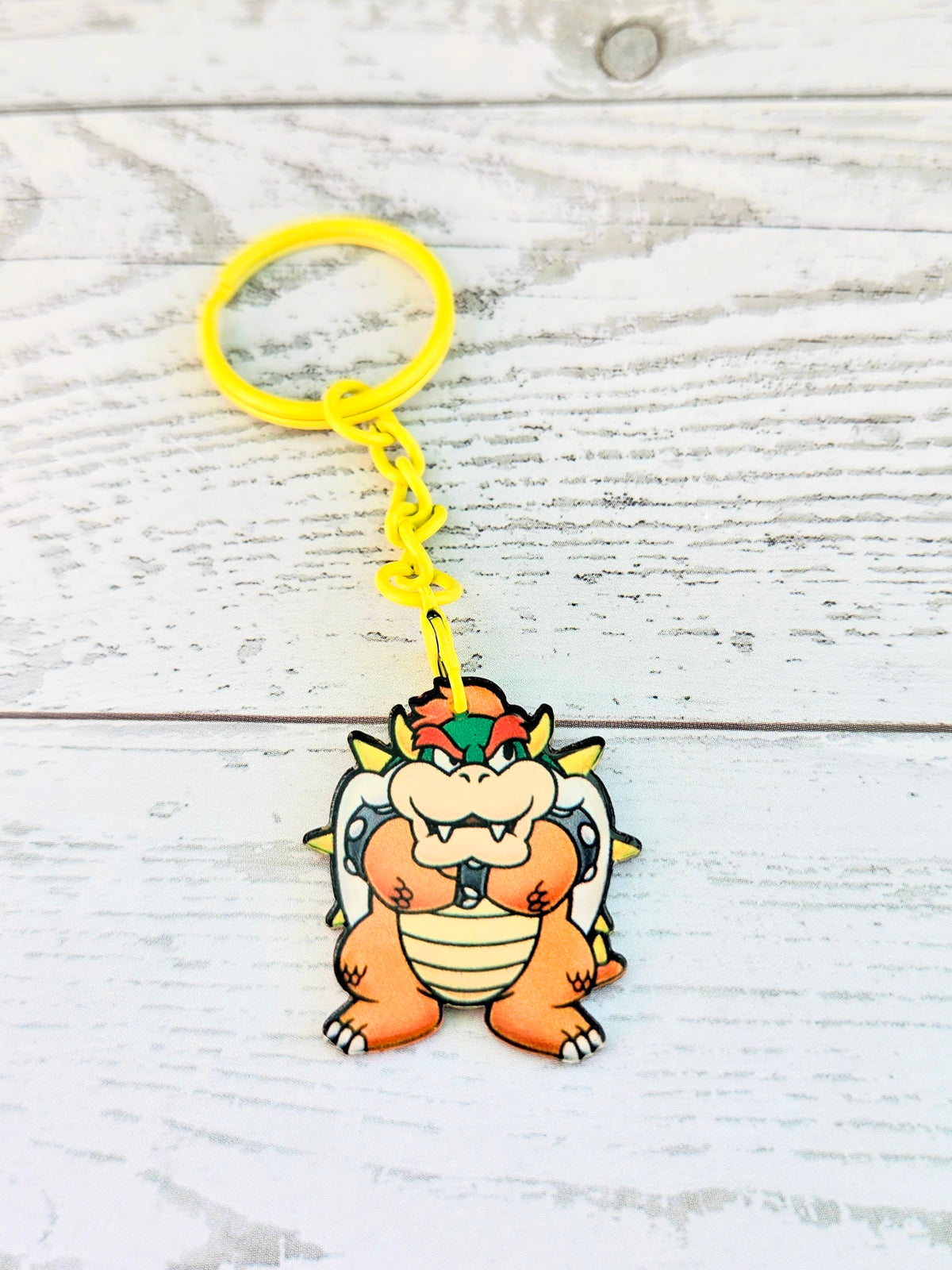 Bowser acrylic keychain with yellow ring and chain, small standing figure