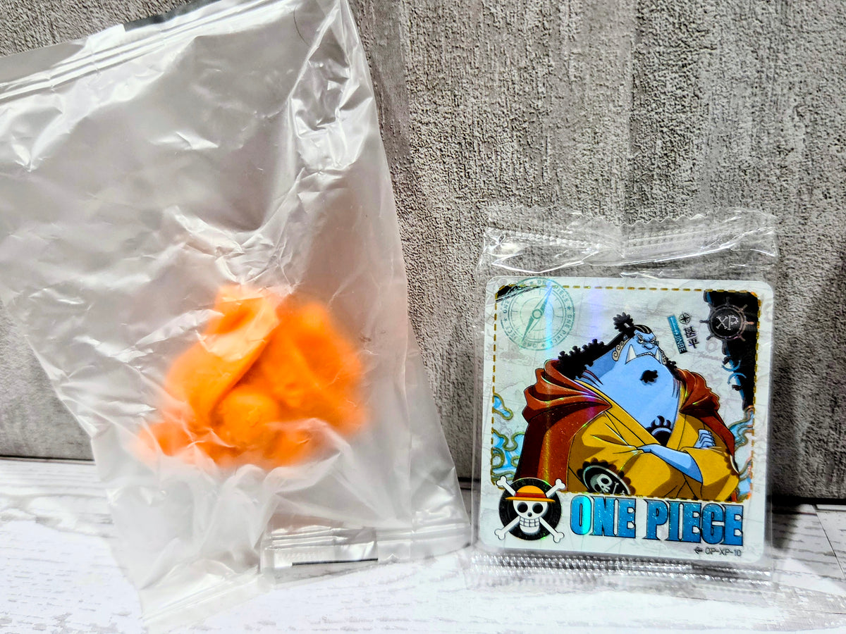 Sealed bag with small orange collectible figure plus One Piece character card