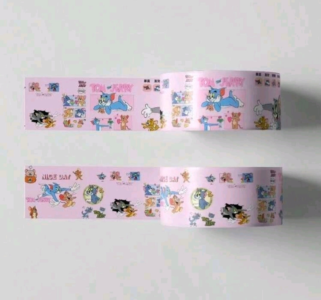 Unrolled pink washi masking tape strips with Tom & Jerry cartoon character blocks