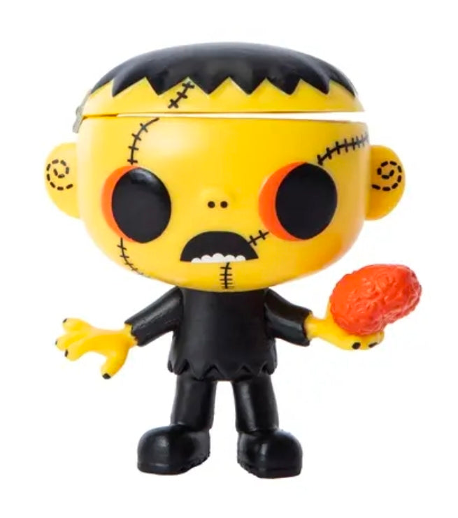 Chibi vinyl Halloween figure holding orange-red pumpkin, black outfit, yellow stitched face