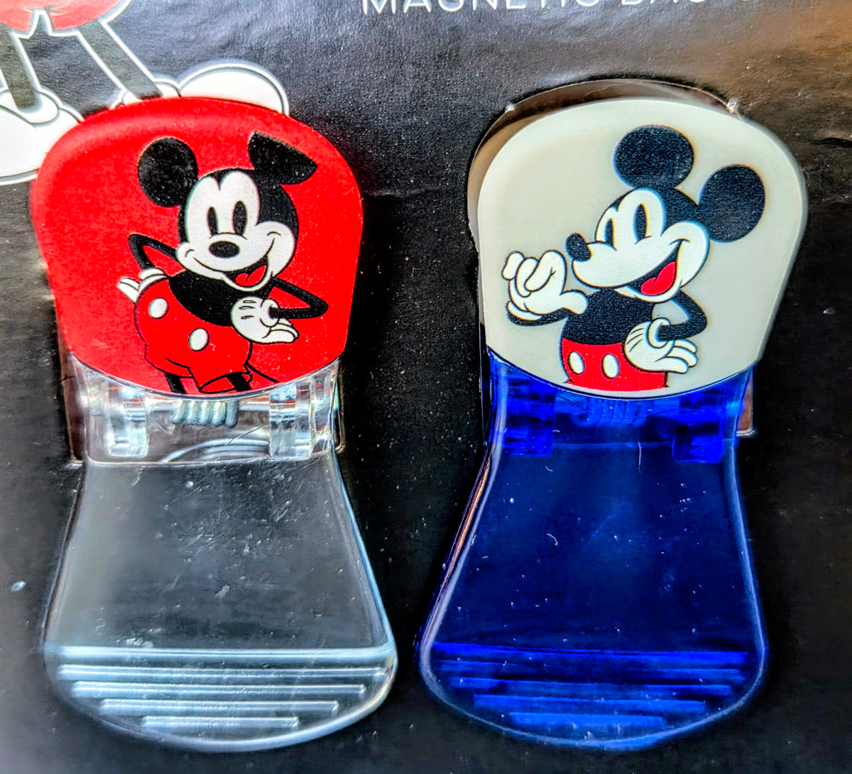 Two clear magnetic bag clips shaped like Mickey and Minnie head icons