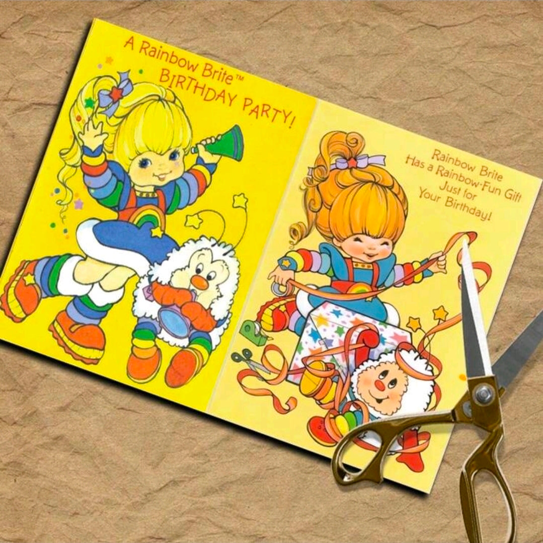 Rainbow Brite scrapbook paper sheets in yellow, featuring birthday party characters and scissors