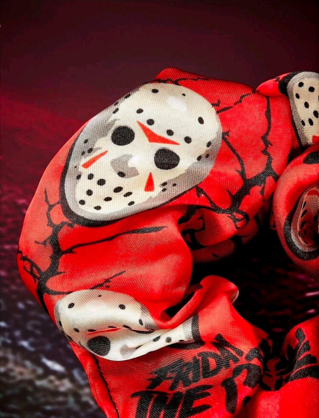 Red character scrunchie with Jason-style hockey mask print and axe graphics