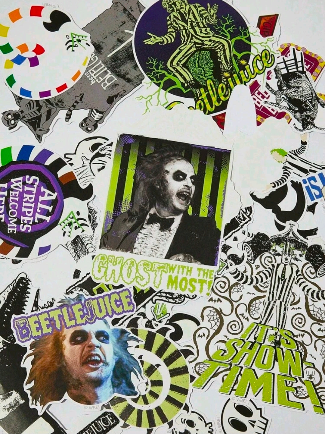 Glow-in-the-dark Beetlejuice-style stickers with skull, stripes, and character art