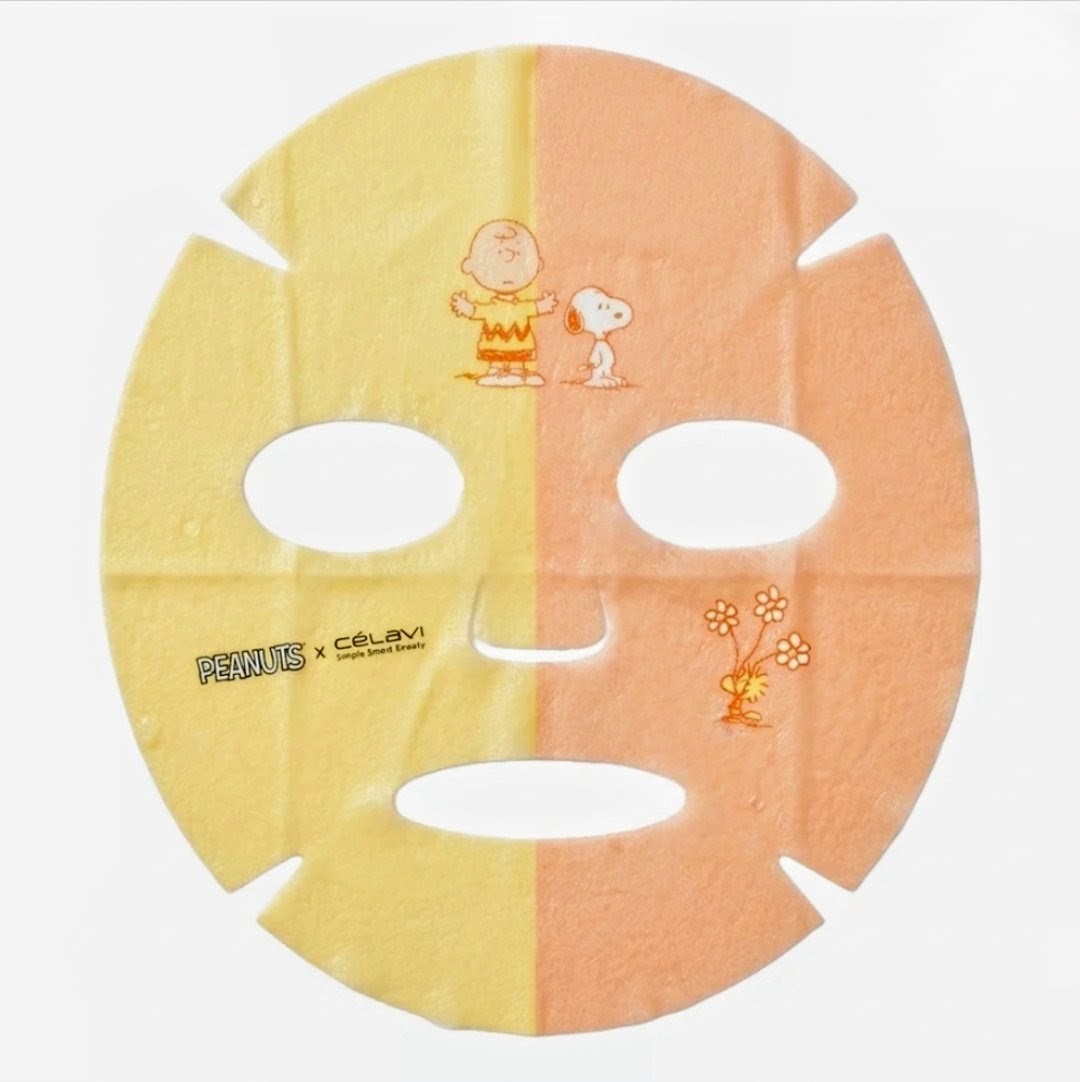 Dual face mask sheet with yellow and peach halves, featuring Snoopy and Charlie Brown art