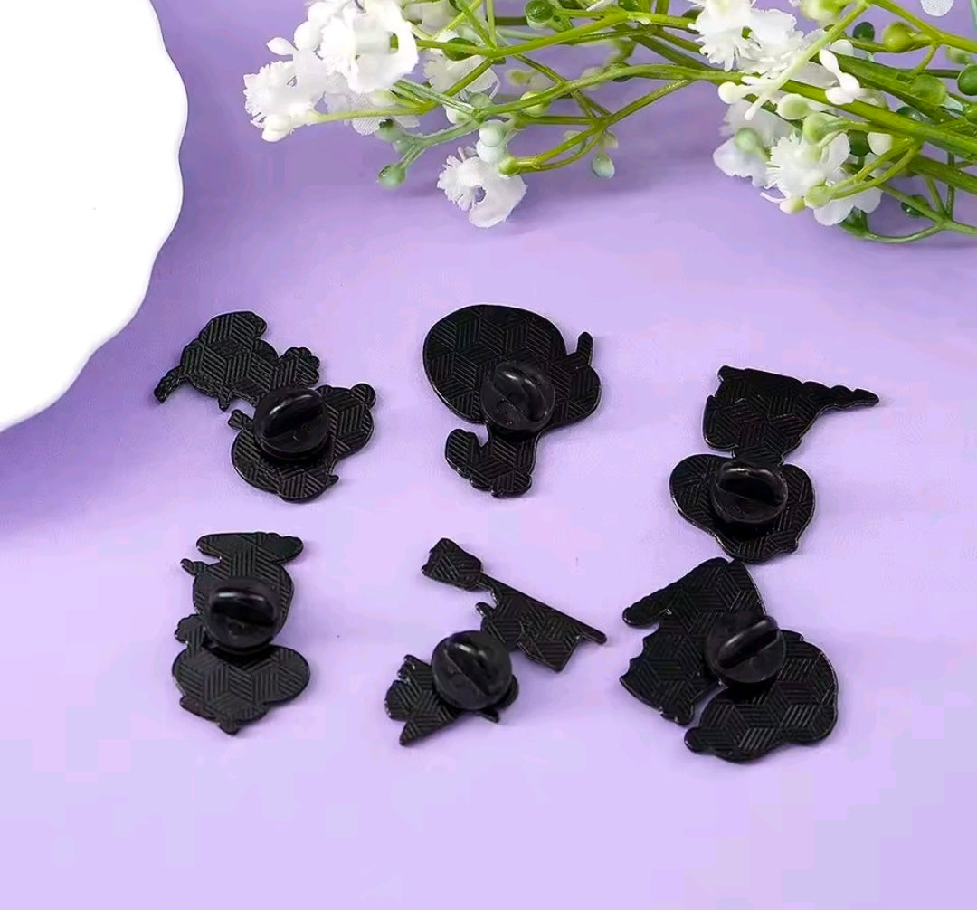 Set of six black Snoopy Halloween enamel pins, laid out for a full view.
