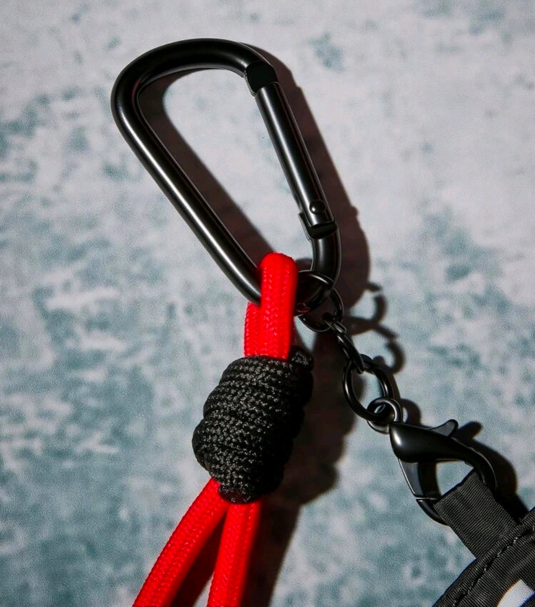 Carabiner clip with red braided cord and black pouch zipper pull