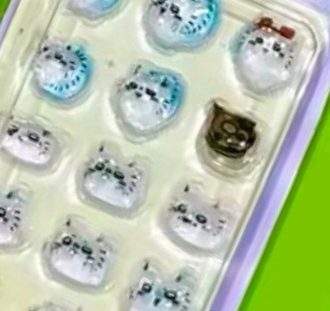 Mini gashapon sticker keychain showing close-up 3D character stickers in clear blister