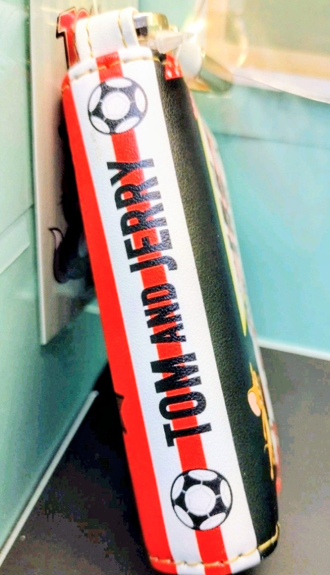 Smart key case on a red-and-white strap with football-themed graphics