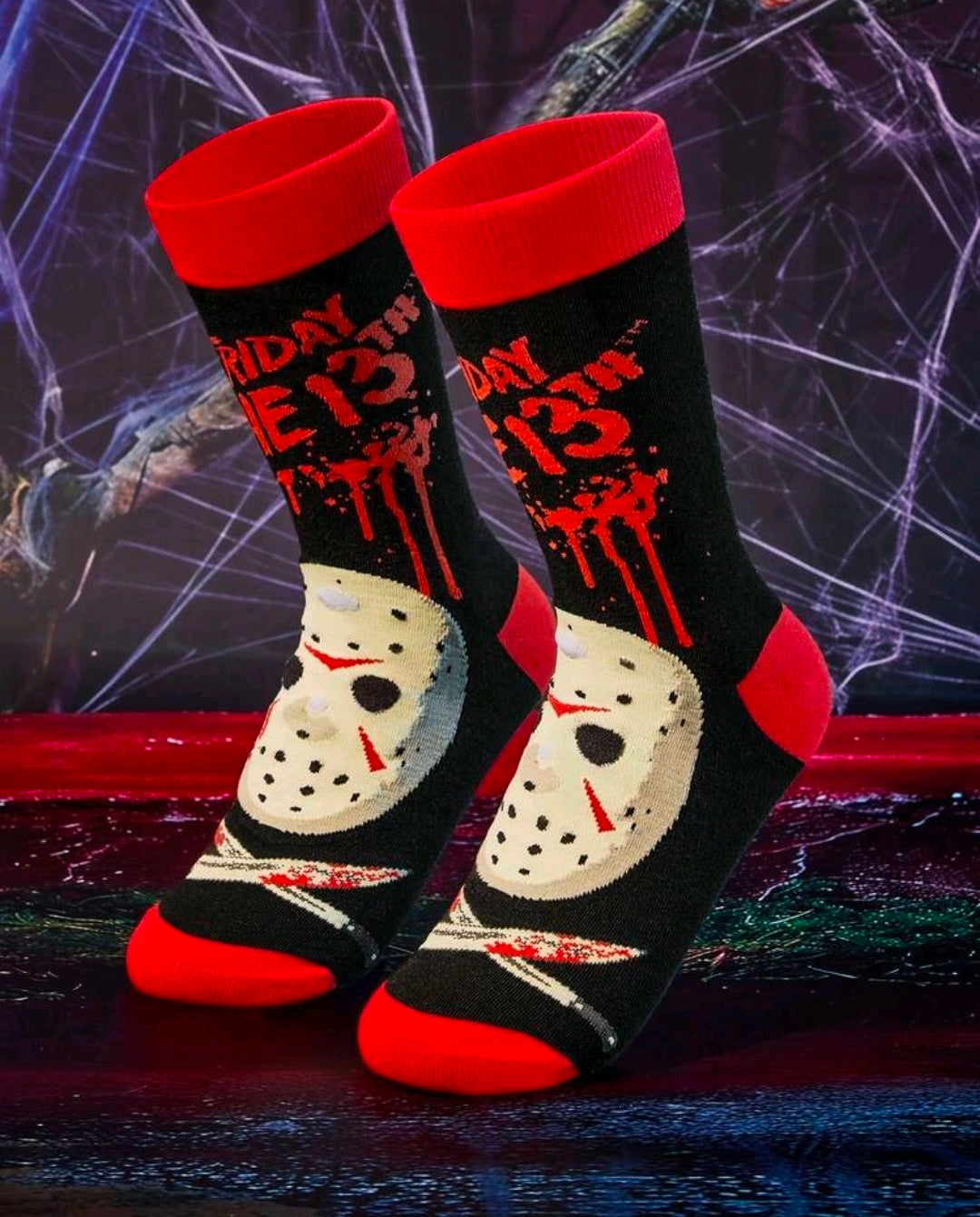 Pair of black crew socks with red cuffs and white hockey-mask graphic