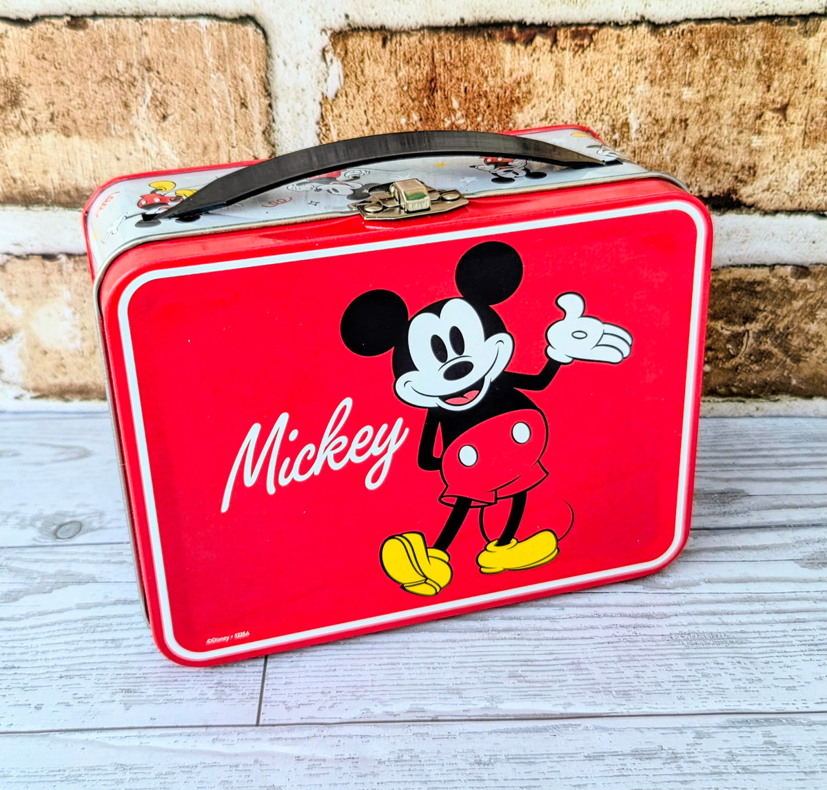 Red rectangular storage tin with Mickey Mouse character graphic on front