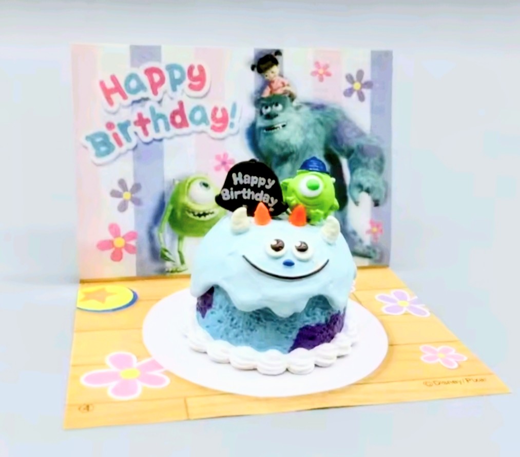 Mini birthday tart figure with blue cake base, purple accents, and monster birthday topper