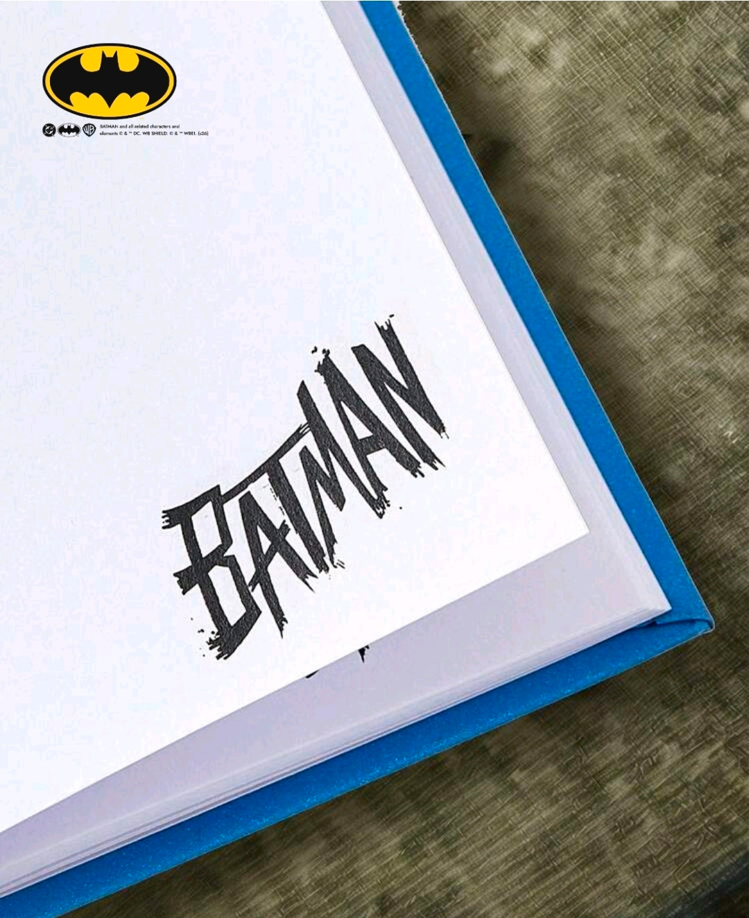 Open blue hardcover journal page with Batman Team Up black graphic