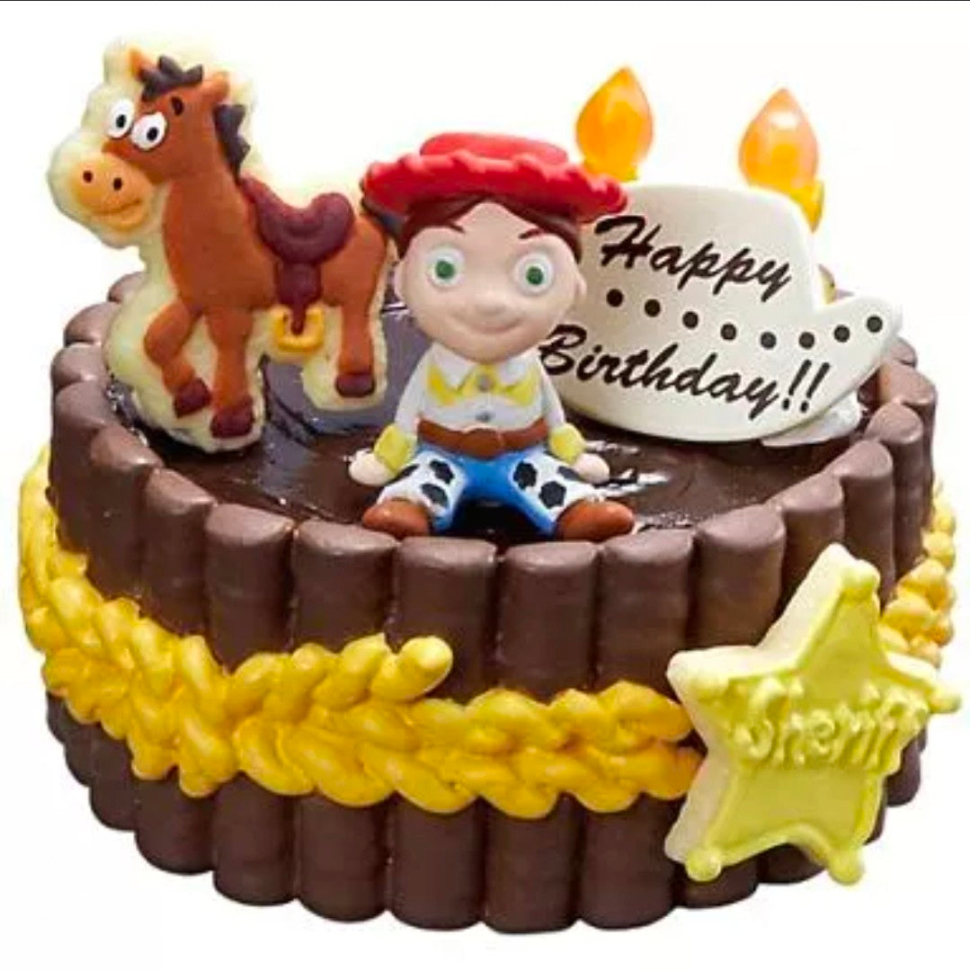 Western birthday cake mini figure close-up with cowboy character and star topper