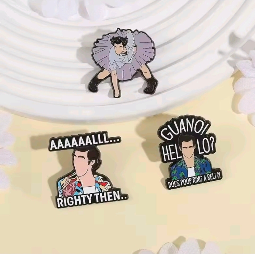 Three enamel pins on light fabric: purple cheering pose, “GUANO! HELLO?”, “RIGHTY THEN..”