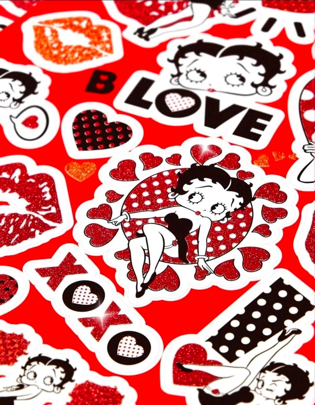 Close-up sticker sheet with glitter accents, hearts, lips, LOVE text, and character
