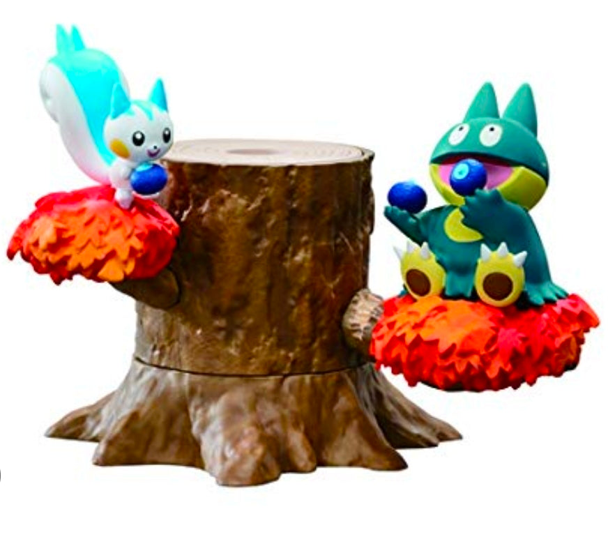 Two blue animal figures on a brown tree-stump, each on red/orange leaf bases