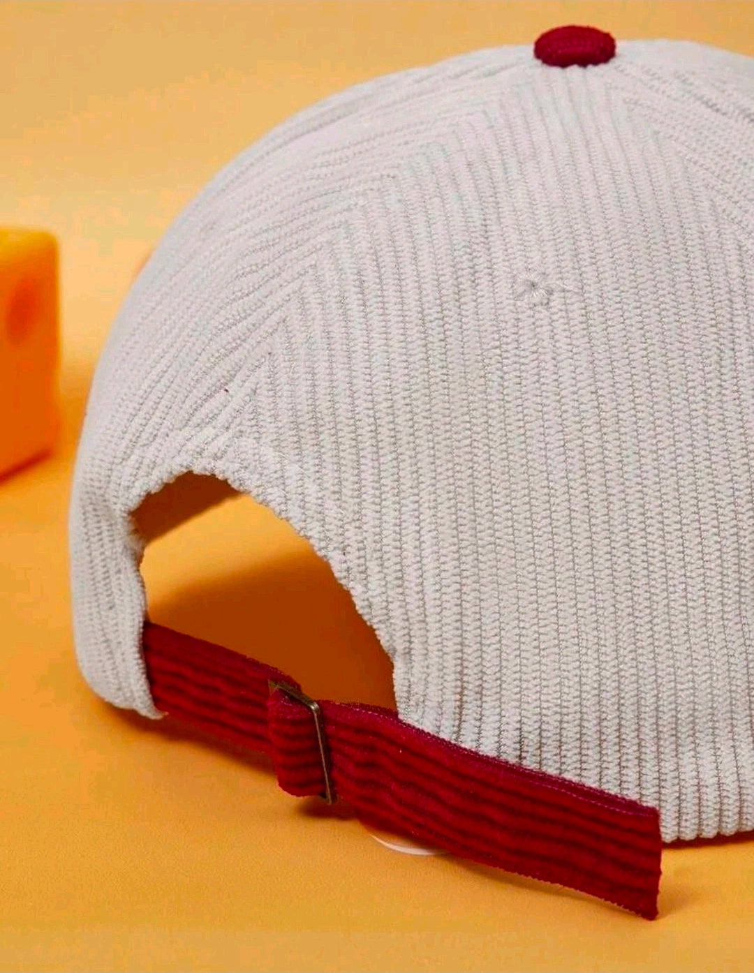 Two-tone baseball cap with light gray crown and burgundy corduroy brim