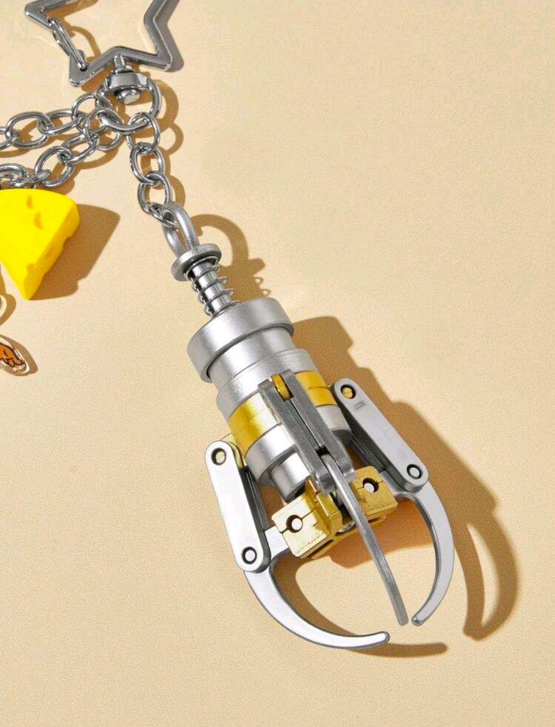 Silver claw machine grabber keychain component with chain and star charm topper