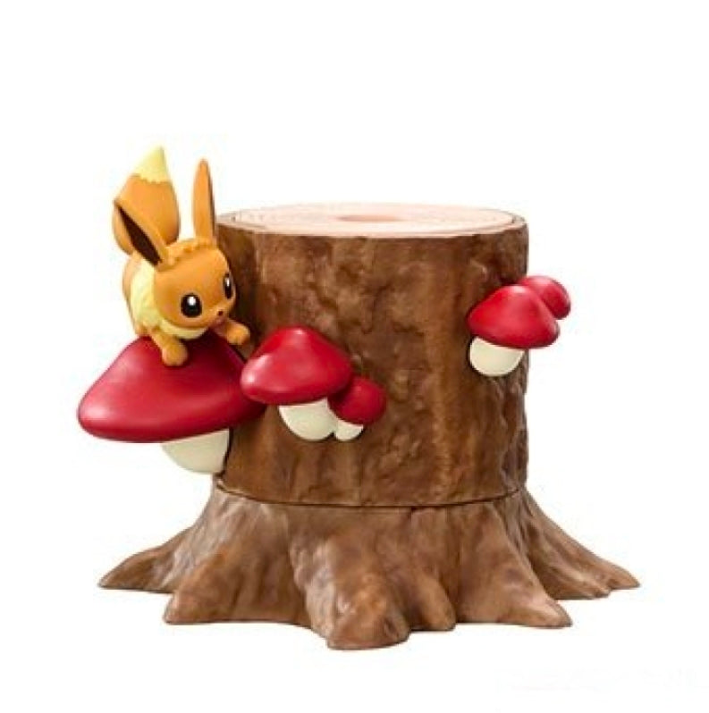 Small yellow rabbit-like figure with red boxing gloves beside a brown tree-stump base
