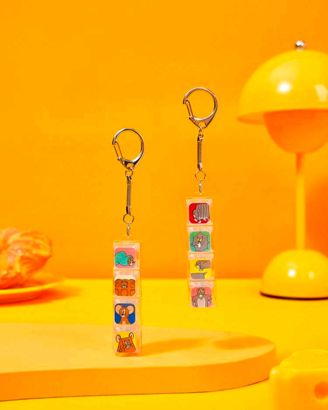 Pair of cartoon keyboard fidget keychains with stacked clear clicker tiles and metal rings