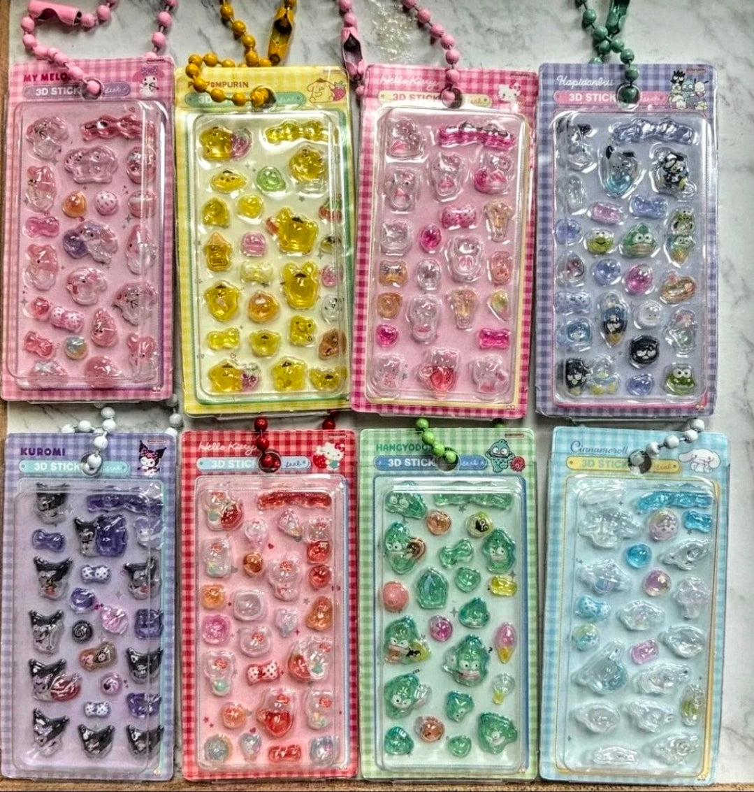 Assorted color 3D sticker keychains in blister packs arranged on a table