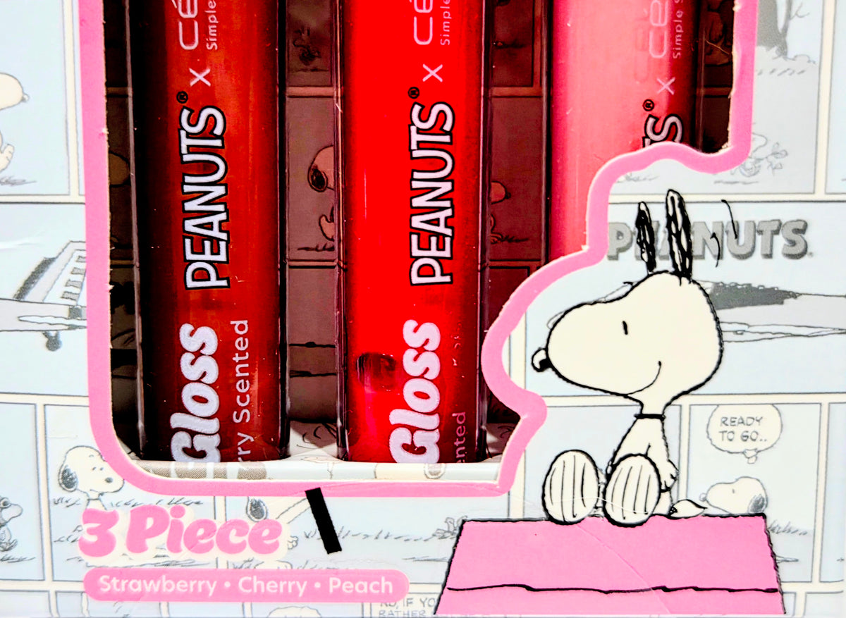 Three lip gloss tubes in a pink tray, printed with Snoopy and Peanuts branding