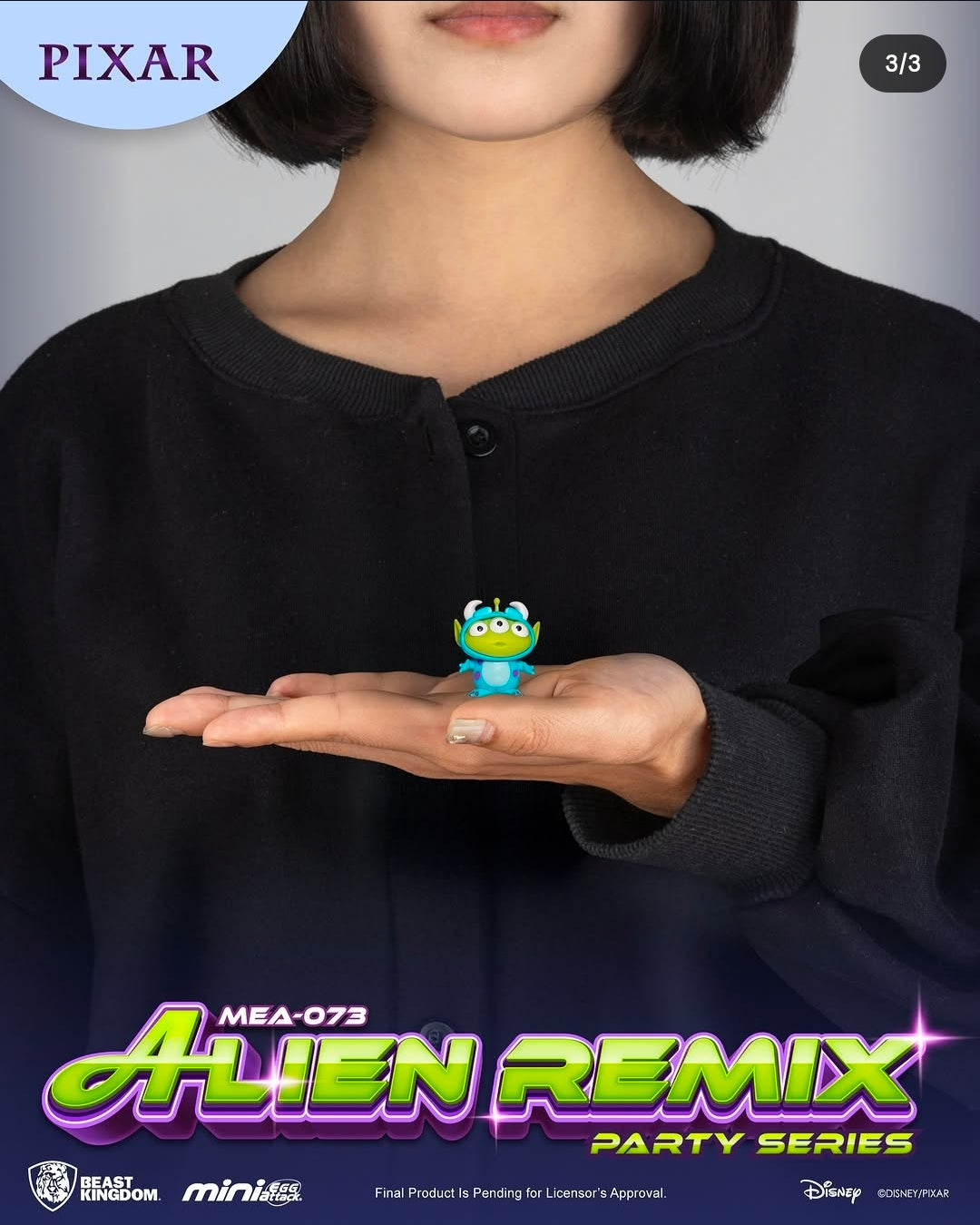 Green and blue alien mini figure held in a child’s open hand