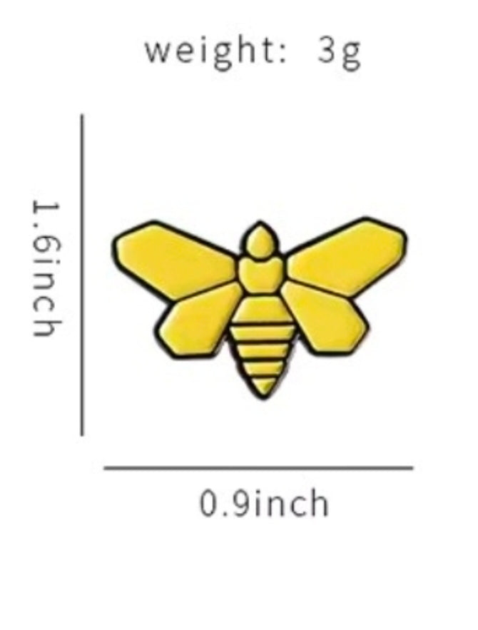 Enamel pin of a yellow bee with black stripes and small stinger detail