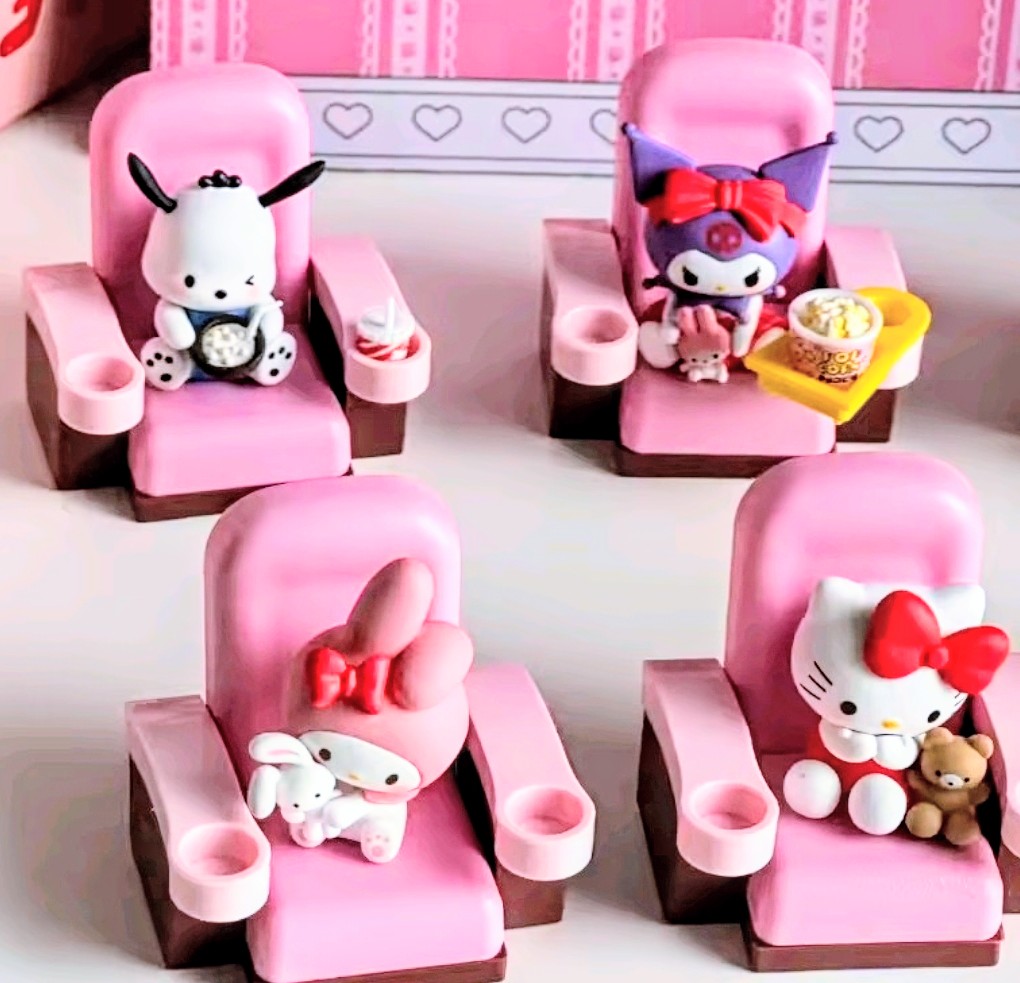 Mini character figures in pink theater-style seats with Hello Kitty and friends
