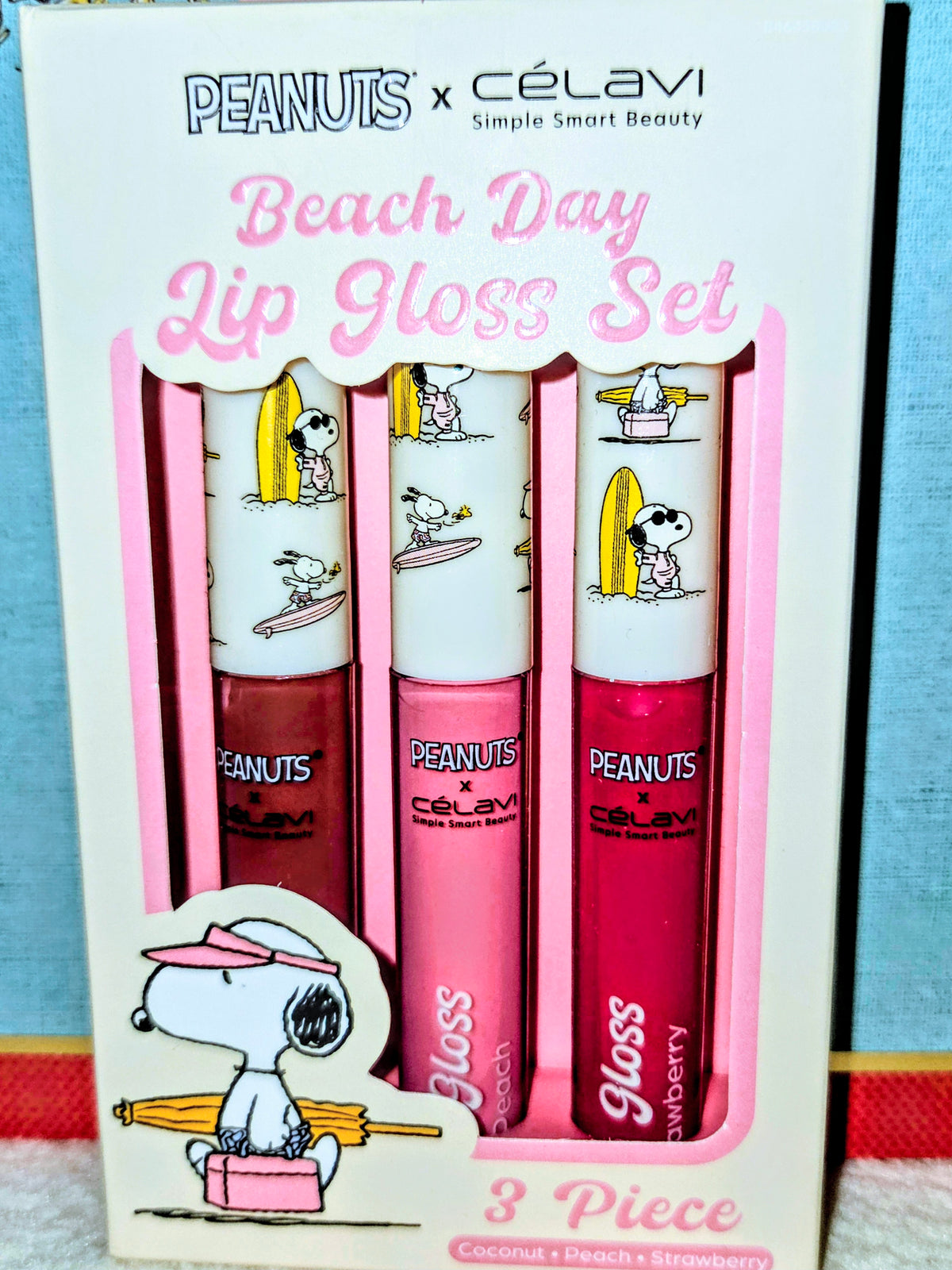 Beach Day 3-piece lip gloss set in retail box, showing three Snoopy-themed tubes