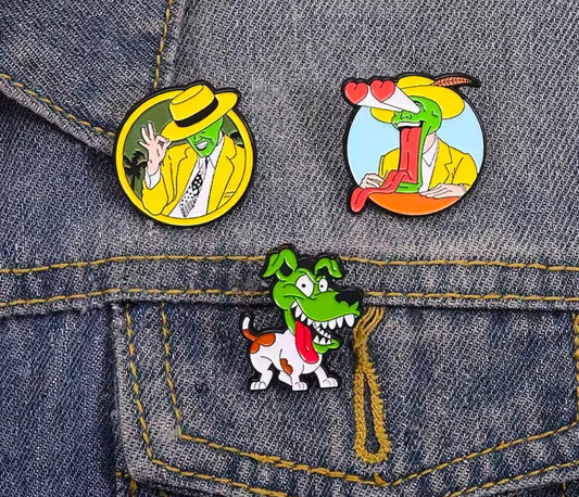 3-piece enamel pin set with three round cartoon character pins on denim fabric