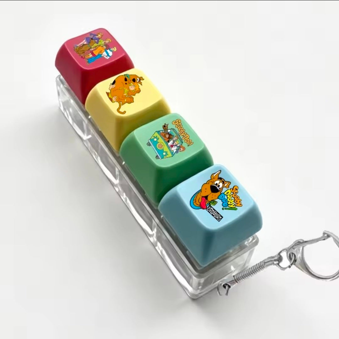 Four-color acrylic keycap fidget set with character-printed caps and metal keychain spring
