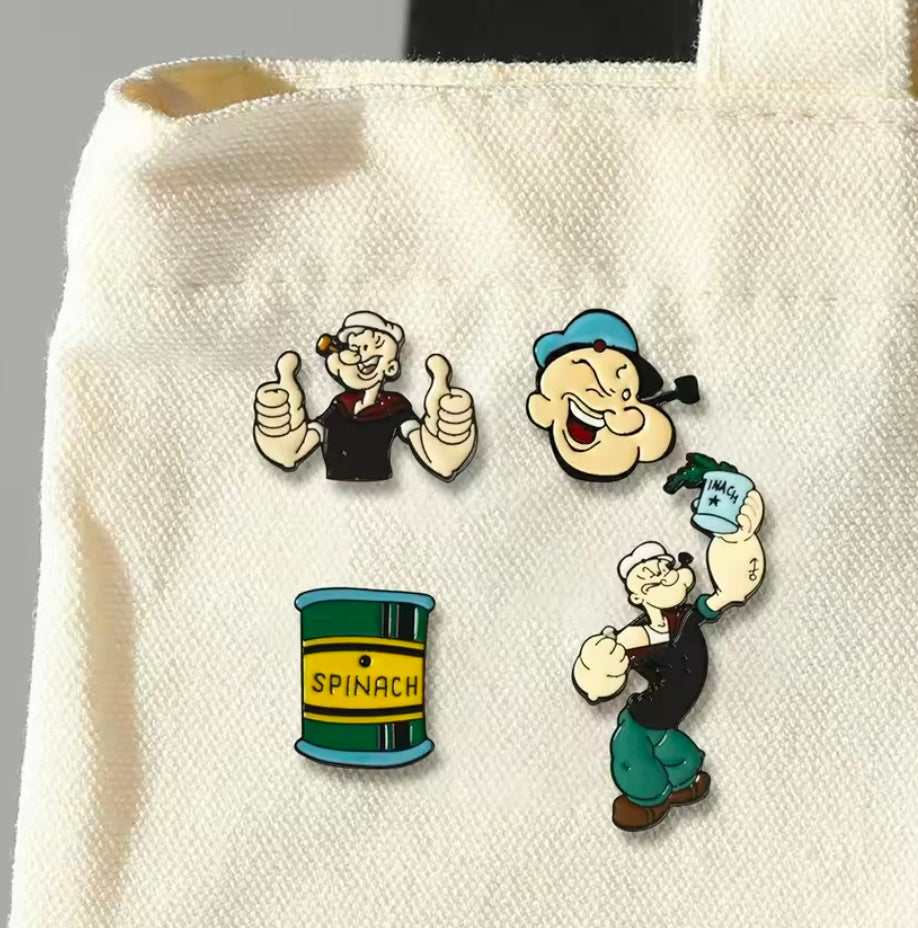 Four-piece Popeye enamel lapel pins: smiling face, Popeye figure, and spinach can