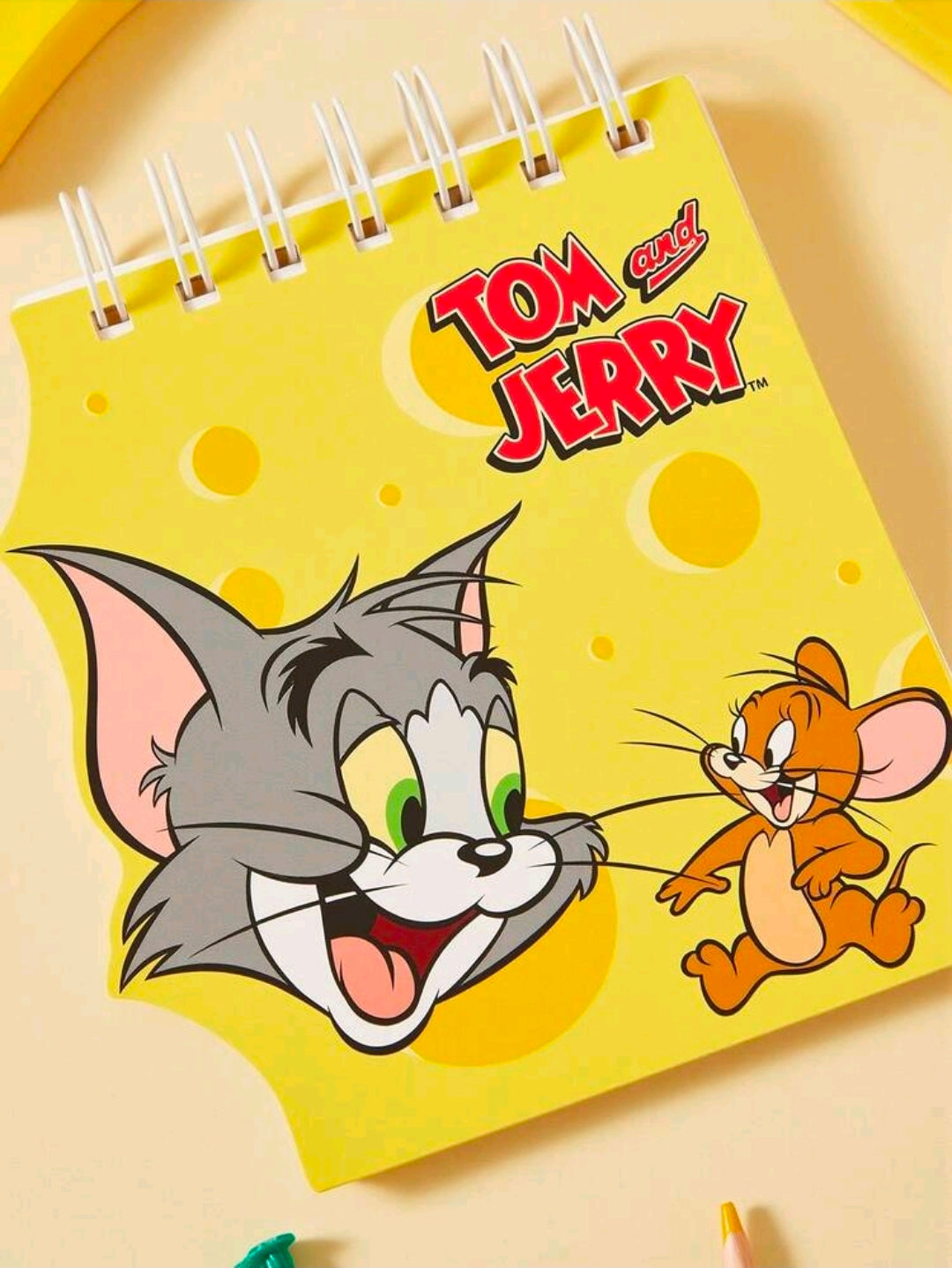Mini spiral notepad with yellow cover featuring Tom and Jerry characters