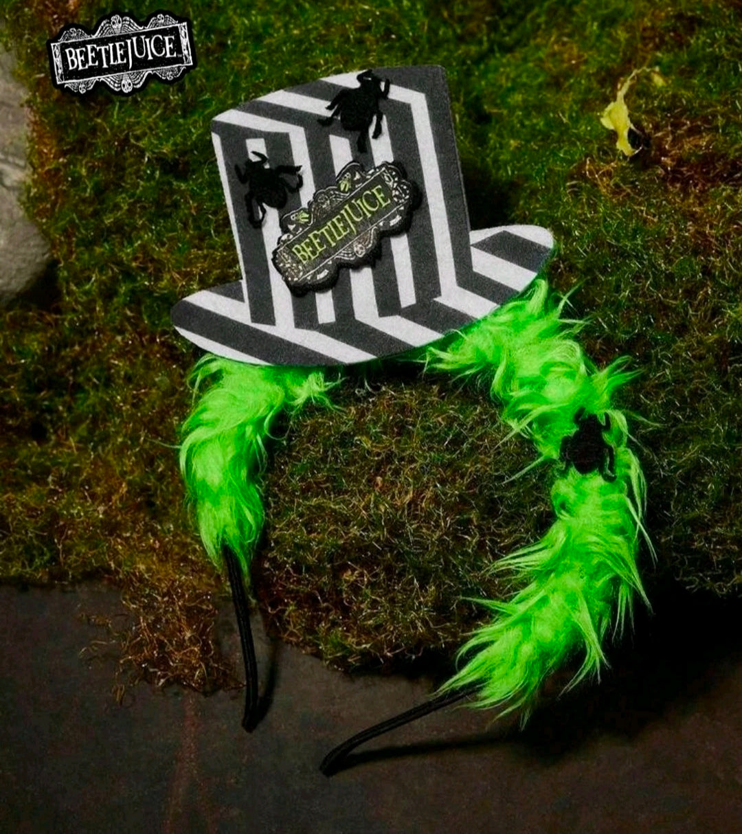 Green feather-fur Halloween headband with striped mini top hat and Beetlejuice logo patch