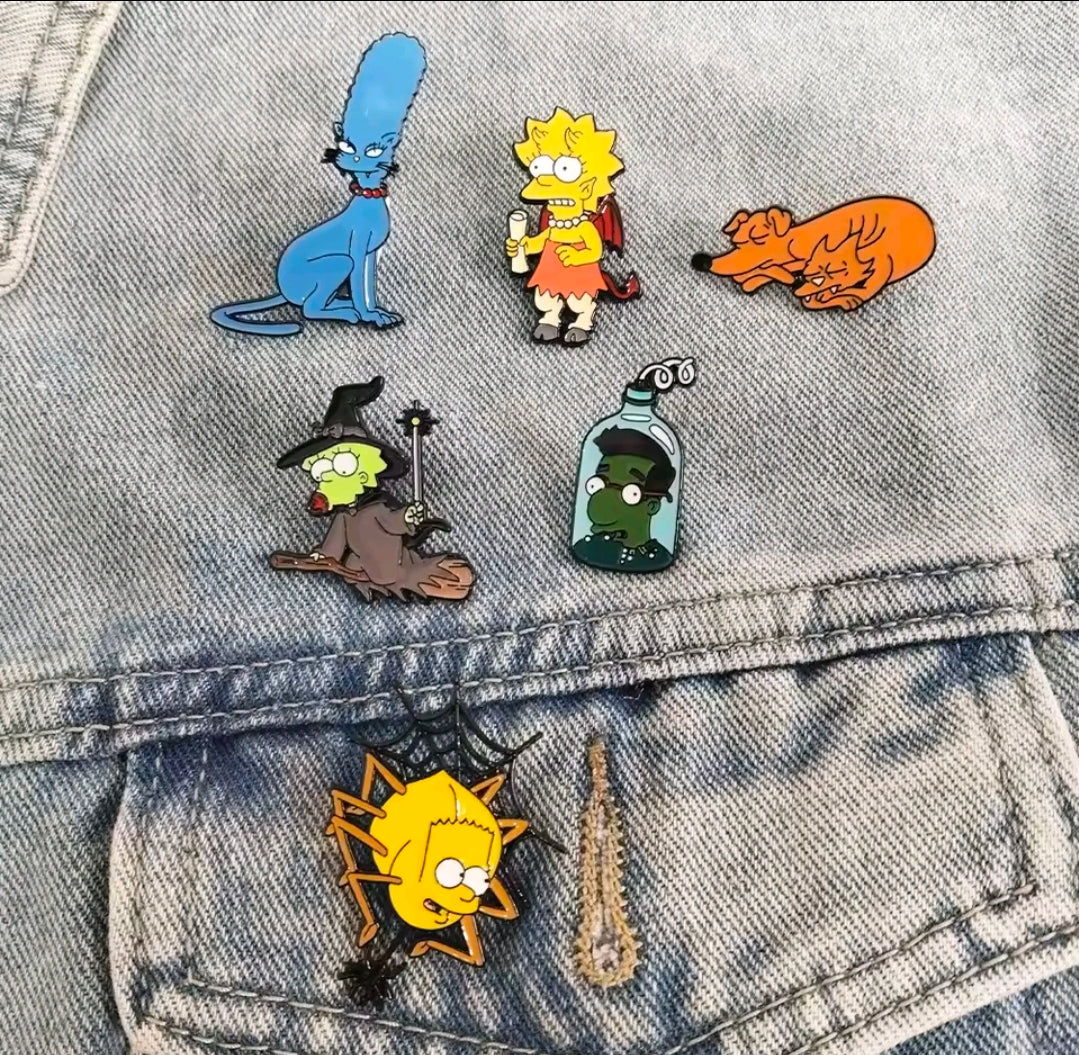 Halloween enamel pins on light blue denim fabric