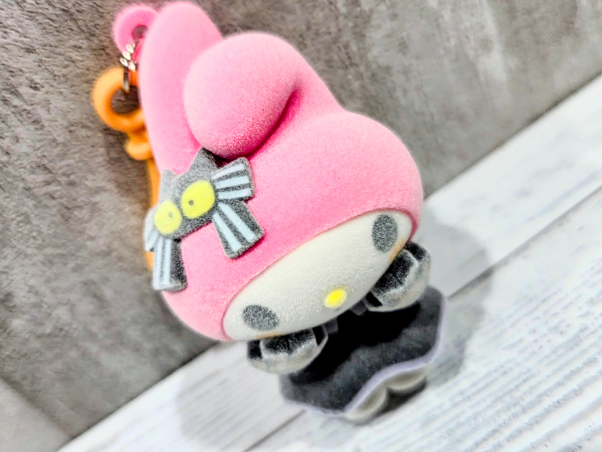 Side view of pink My Melody witch-hat flocked bag clip with orange loop keyring