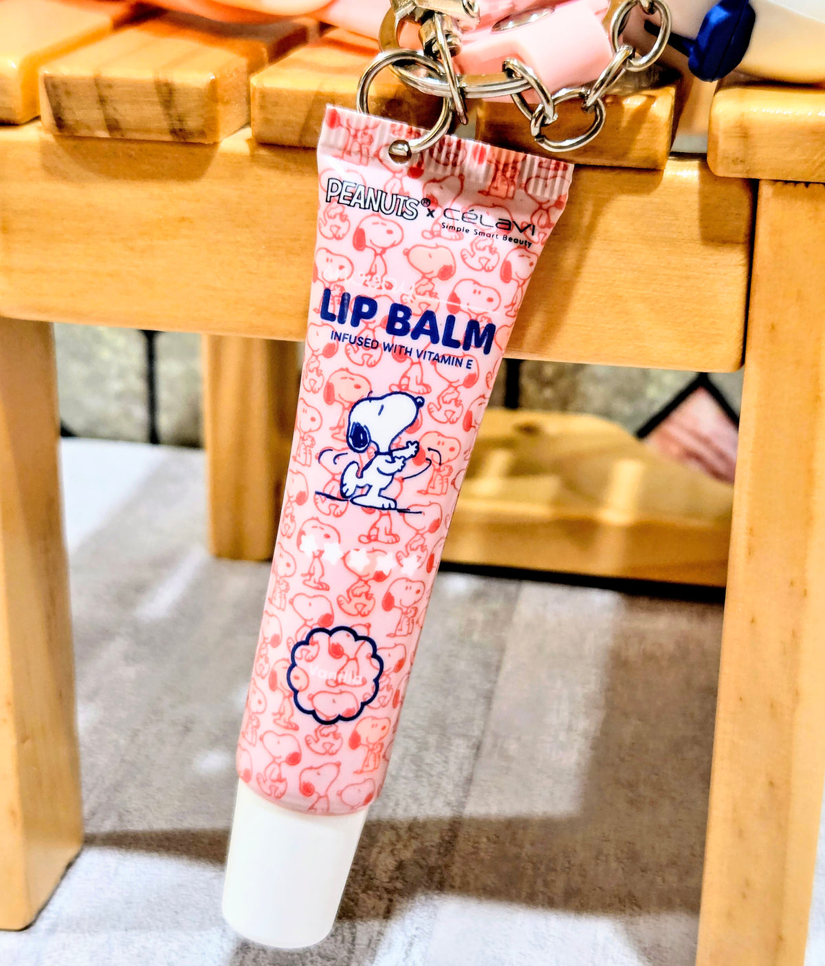 Lip balm tube keychain with Snoopy pattern and flip-top cap