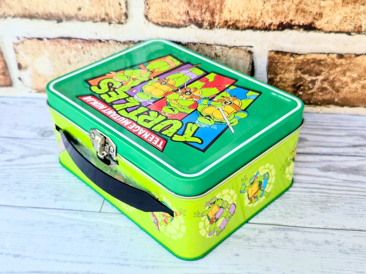 Green Teenage Mutant Ninja Turtles storage tin with carry handle and artwork