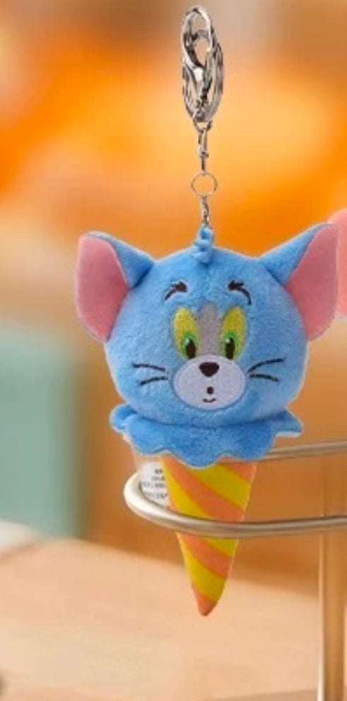 Blue Tom cat plush keychain hanging from a metal ring, in yellow-striped ice cream cone