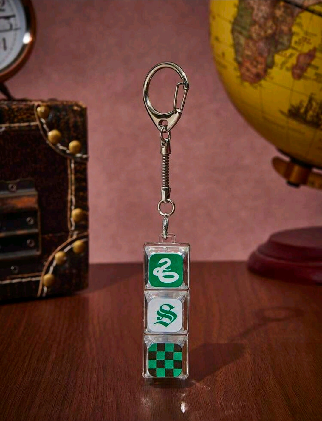 Slytherin fidget keychain charm with metal clip, spring, and green snake blocks