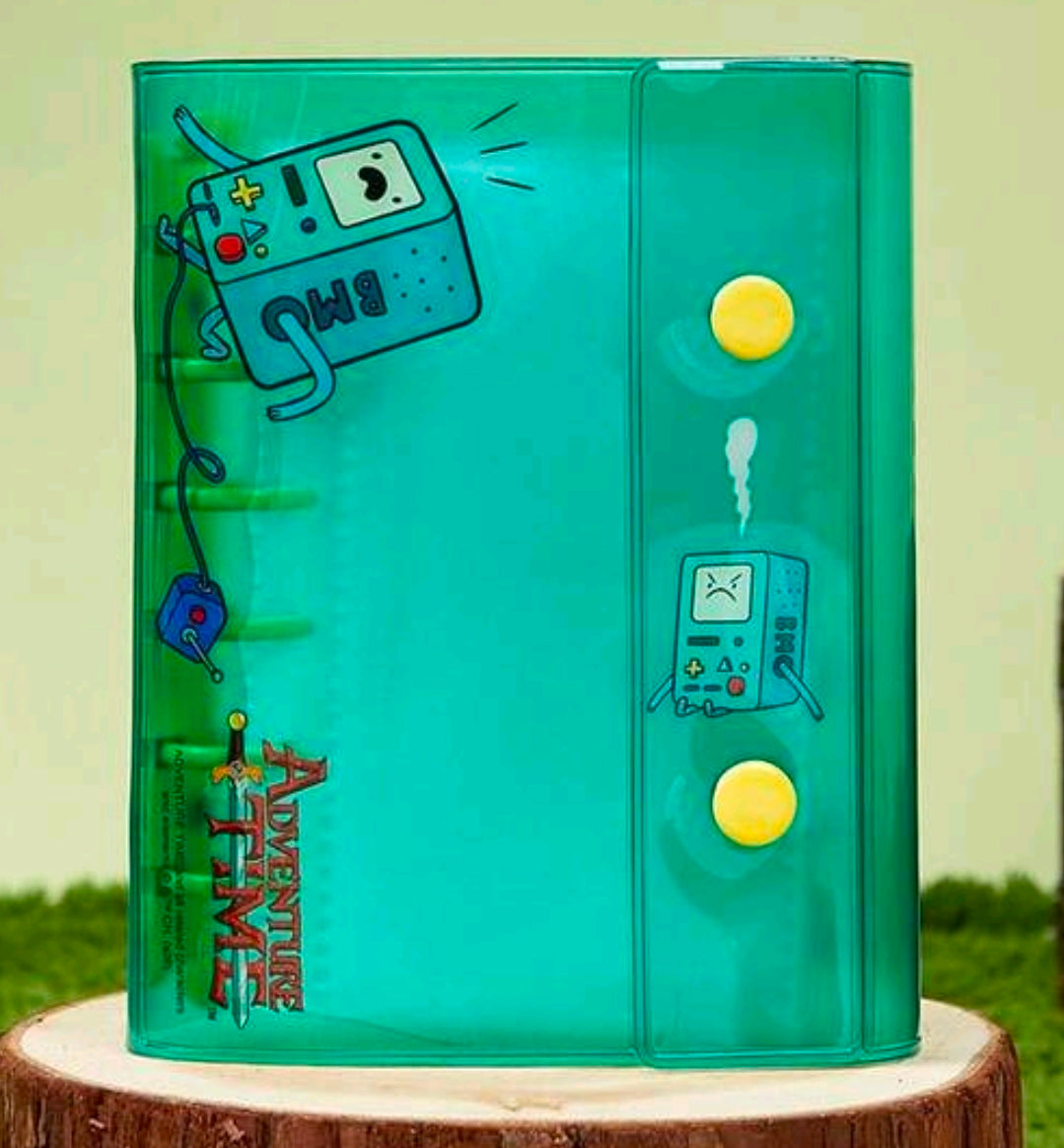 Green A7 mini binder with BMO artwork and sticker-style controller icons.