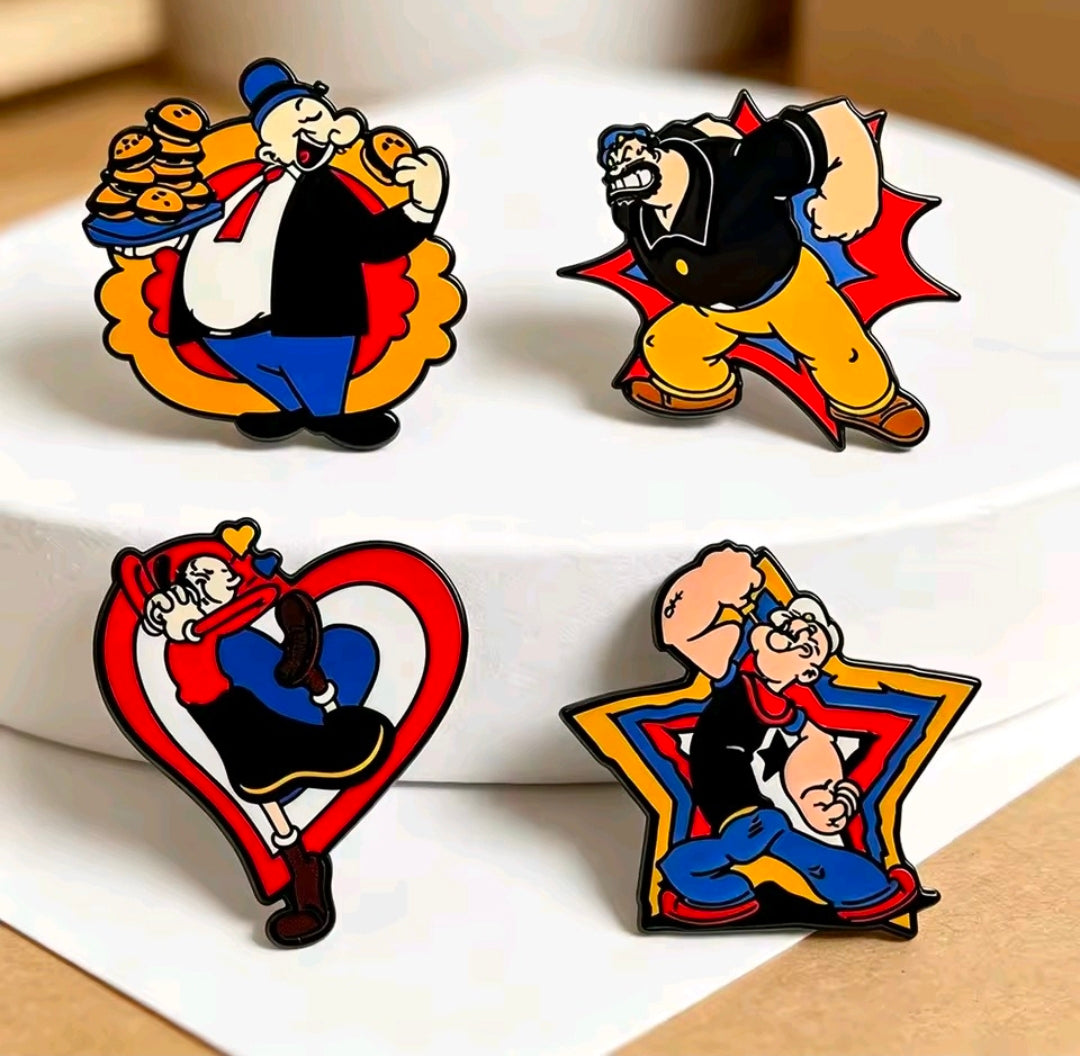 Four cartoon enamel lapel pins on a white case: Popeye, Brutus, Olive Oyl, Wimpy.