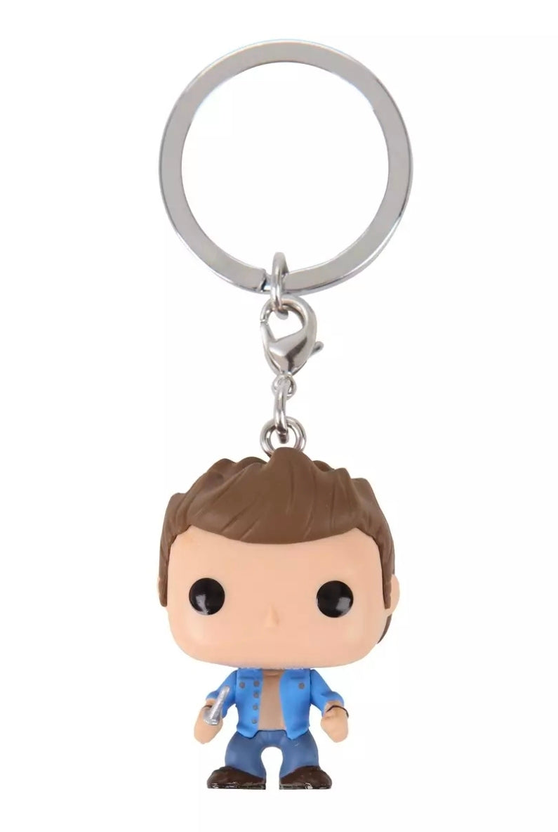 Brown-haired vinyl keychain figure with blue outfit and metal keyring