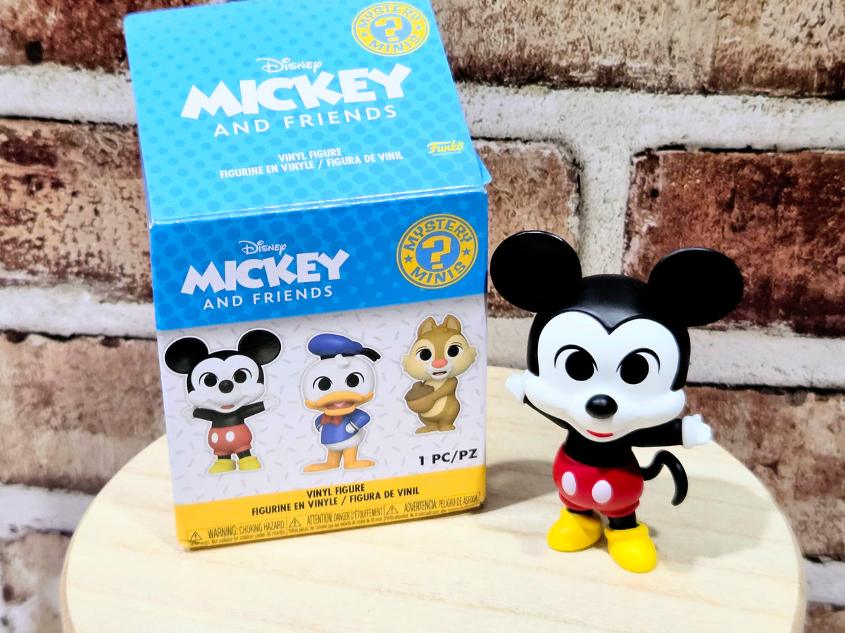 Mickey Mouse vinyl figure with blue mystery box packaging, red outfit and yellow shoes.